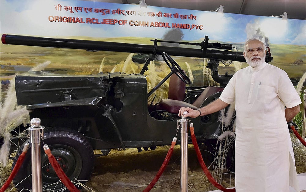 Prime Minister Narendra Modi poses with jeep of with Param Vir Chakra awardee Shaheed Abdul Hameed in an exhibition on Golden Jubilee of the 1965 Indo-Pak War, in New Delhi.