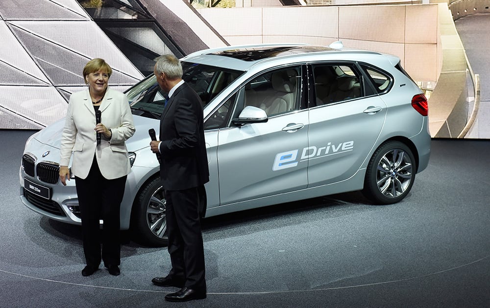 German Chancellor Angela Merkel stands in front of a BMW 225xe on the first day of the Frankfurt Auto Show IAA in Frankfurt, Germany.