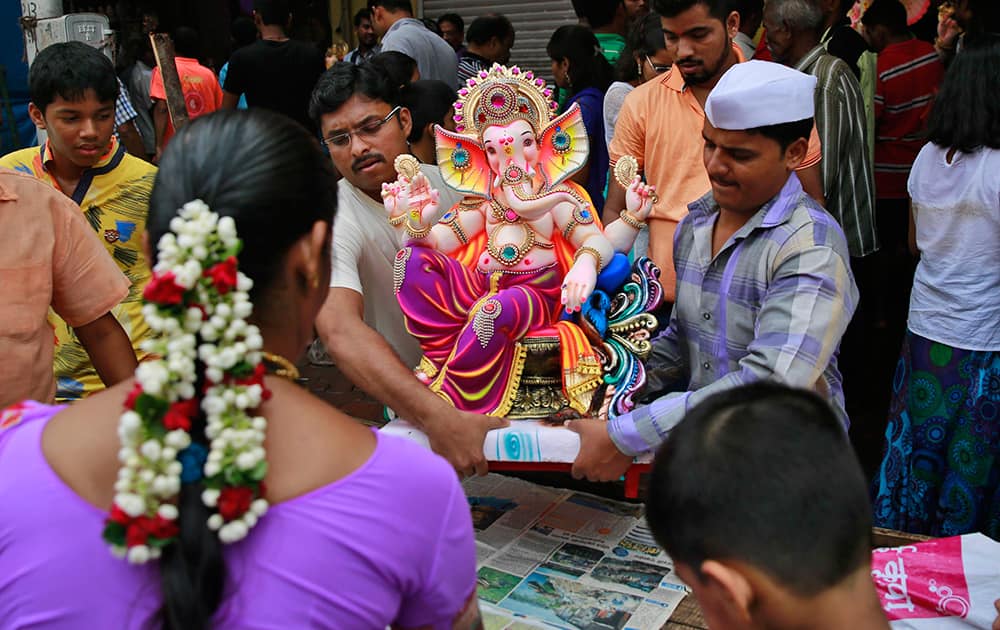 Devotees carry an idol of elephant-headed Hindu God Ganesha during Ganesh Chaturthi festival celebrations in Mumbai.