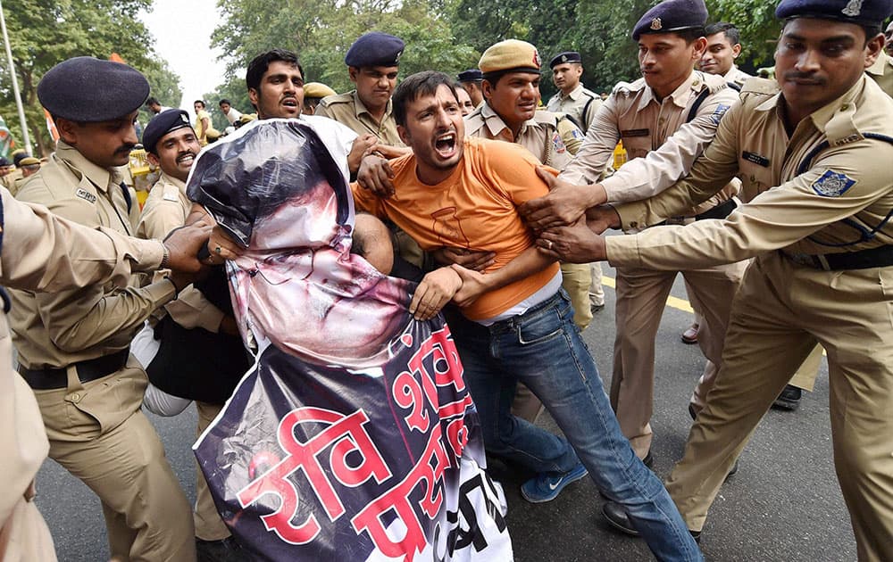 Police detain Indian Youth Congress activists during a protest against govts move to withdraw stamps on Rajiv Gandhi and Indira Gandhi in New Delhi.