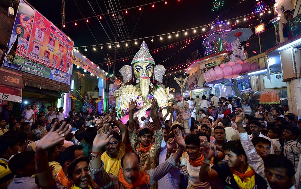 People take part in the immersion procession of Lord Ganesh during Ganesh Chaturthi festival in Moradabad.