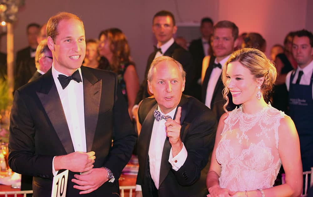 Britain's Prince William, the Duke of Cambridge, left, CEO of Tusk Trust Charlie Mayhew and British singer Joss Stone smile, during the Tusk Trust conservation charity 25th Anniversary Ball, at Syon House, in London.