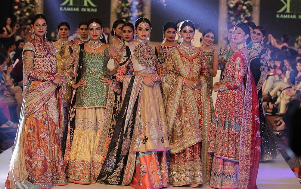 Pakistani models present creations by the House of Kamiar Rokni during the Pakistan Fashion Design Council Bridal Week in Lahore, Pakistan.