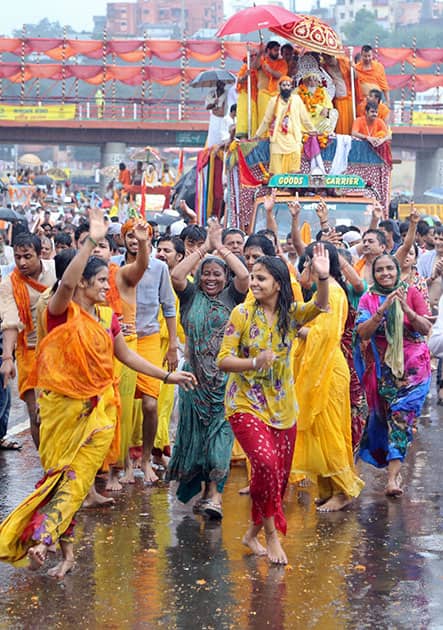 Hindu devotees dance at a procession during the ongoing Kumbh Mela in Nashik, Maharashtra.