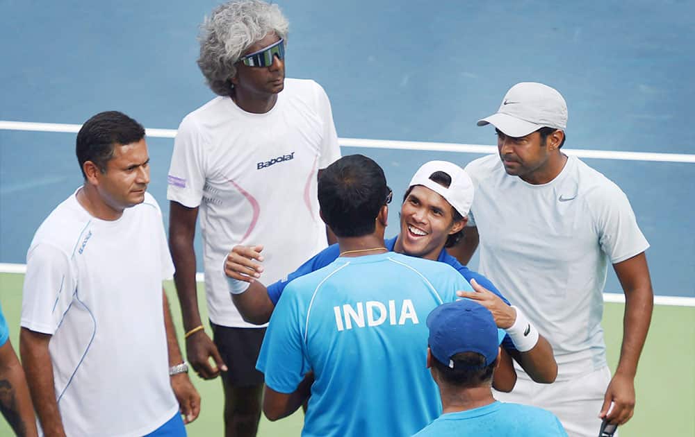 Somdev Devvarman celebrates with team mates after winning his singles match against Czech Republics Jiri Vesely during the first days play of the Davis Cup at The RK Khanna Tennis Stadium in New Delhi.