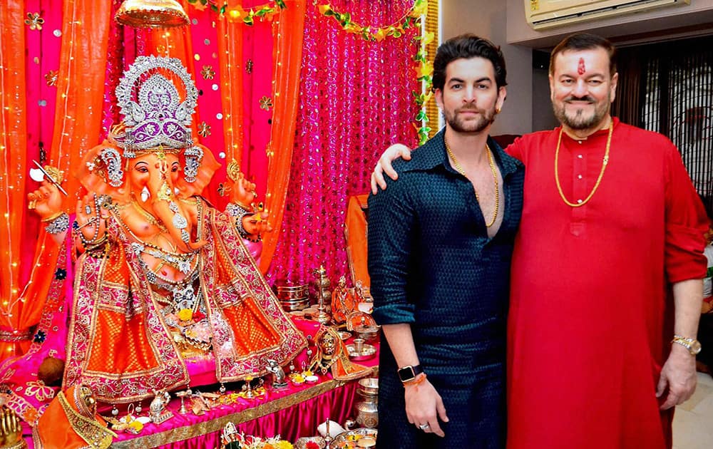 Neil Nitin Mukesh with his father singer Nitin Mukesh (R) during the Ganesh festival celebrations at their residence in Mumbai.