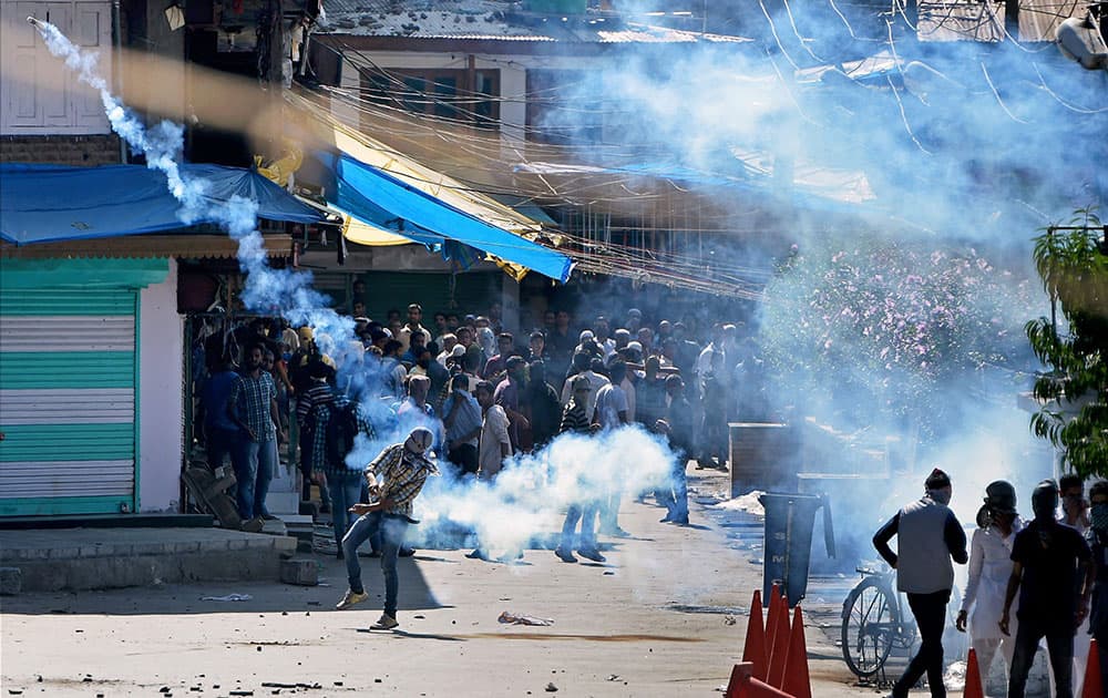 Youths throw stones and teargas shells back on police during clash between police and protesters who were protesting against the Beef ban by J&K High Court at Nowhatta in Srinagar.