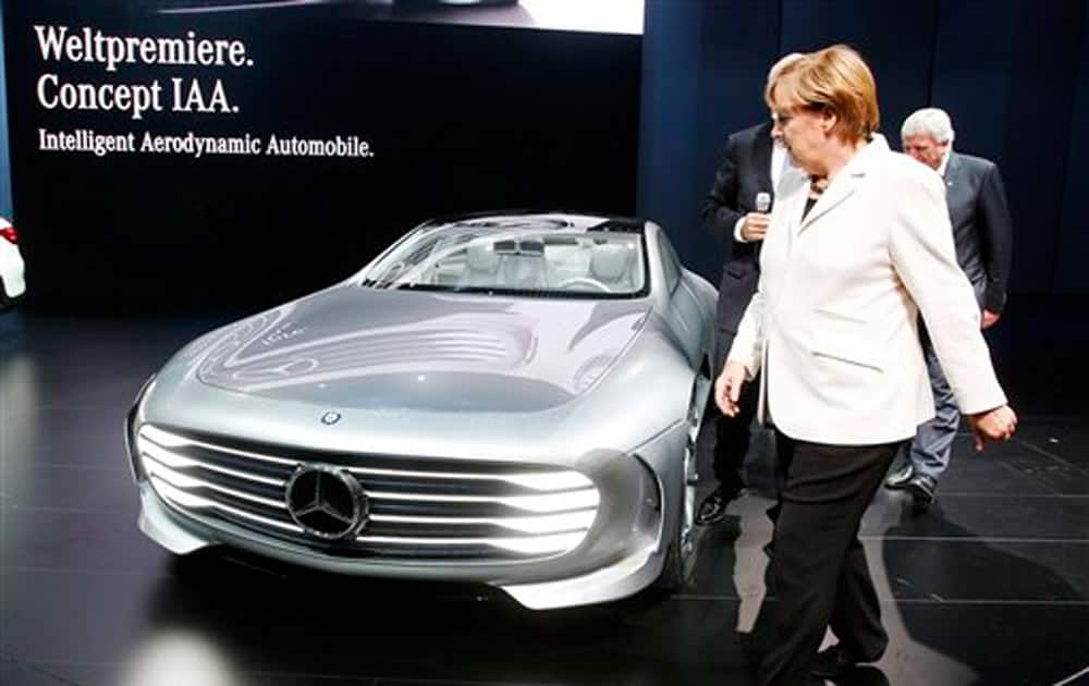 German Chancellor Angela Merkel stands next to a Mercedes Concept car IAA as she visits the Frankfurt Auto Show IAA in Frankfurt, Germany.