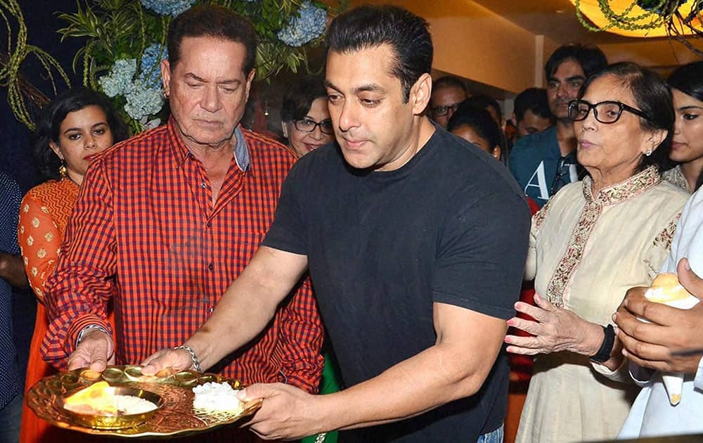 Bollywood actor Salman Khan with father Salim Khan and mother Salma offering prayers to Lord Ganesha at their residence in Mumbai.