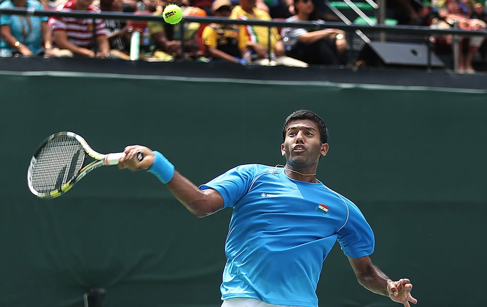 Rohan Bopanna returns the ball to Czech Republic’s Adam Pavlasek and Radek Stepanek during a Davis Cup World Group play-off doubles tennis match in New Delhi.