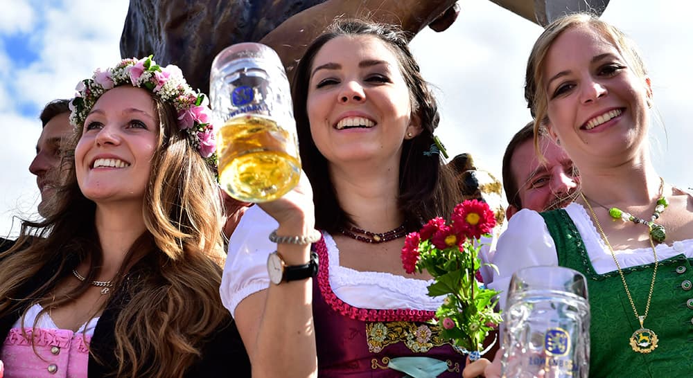 Young women celebrate the opening of the 182. Oktoberfest beer festival in Munich, southern Germany.