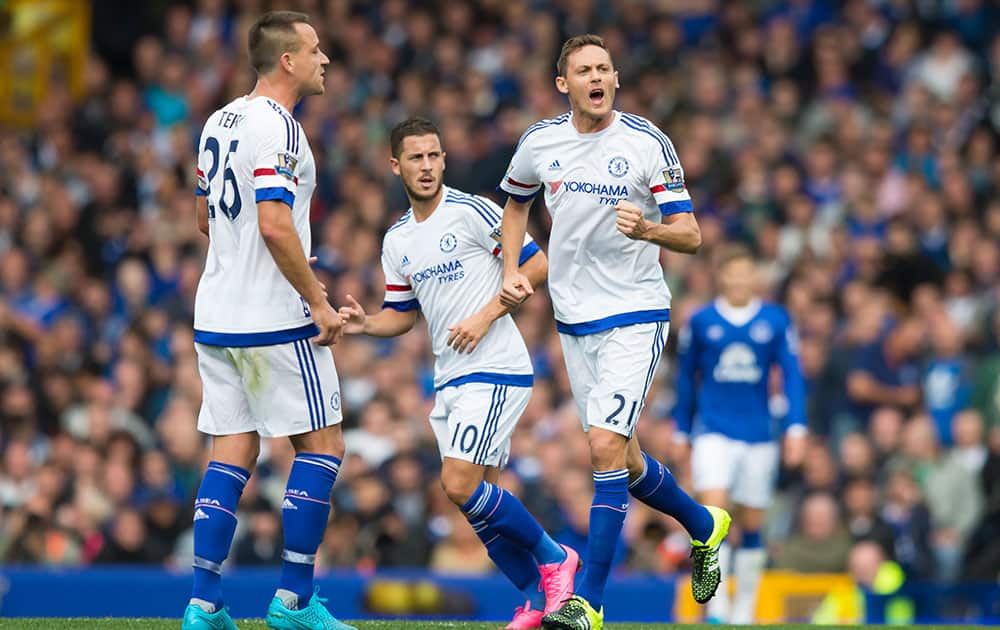 Chelsea's Nemanja Matic, centre right, celebrates after scoring during the English Premier League soccer match between Everton and Chelsea at Goodison Park Stadium, Liverpool, England.