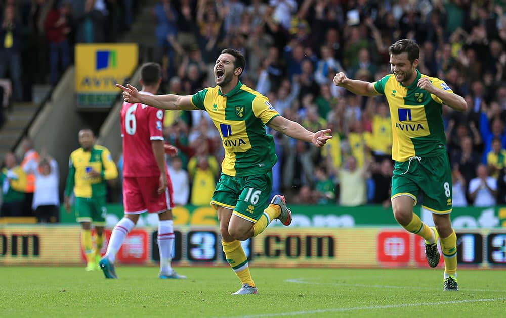 Norwich City's Matt Jarvis, center, celebrates scoring his side's third goal of the game during their English Premier League soccer match against Bournemouth at Carrow Road, Norwich, England.