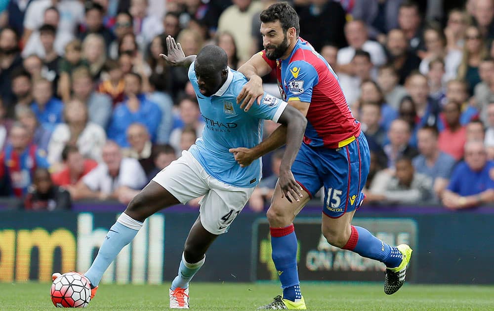 Manchester City’s Yaya Toure, left, competes for the ball with Crystal Palace’s Mile Jedinak during the English Premier League soccer match between Crystal Palace and Manchester City at Selhurst Park, London.