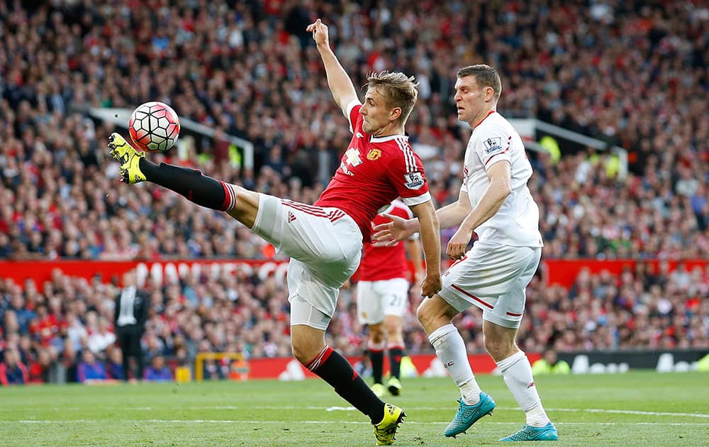 Manchester United's Luke Shaw controls the ball during the English Premier League soccer match between Manchester United and Liverpool at Old Trafford Stadium, Manchester, England.