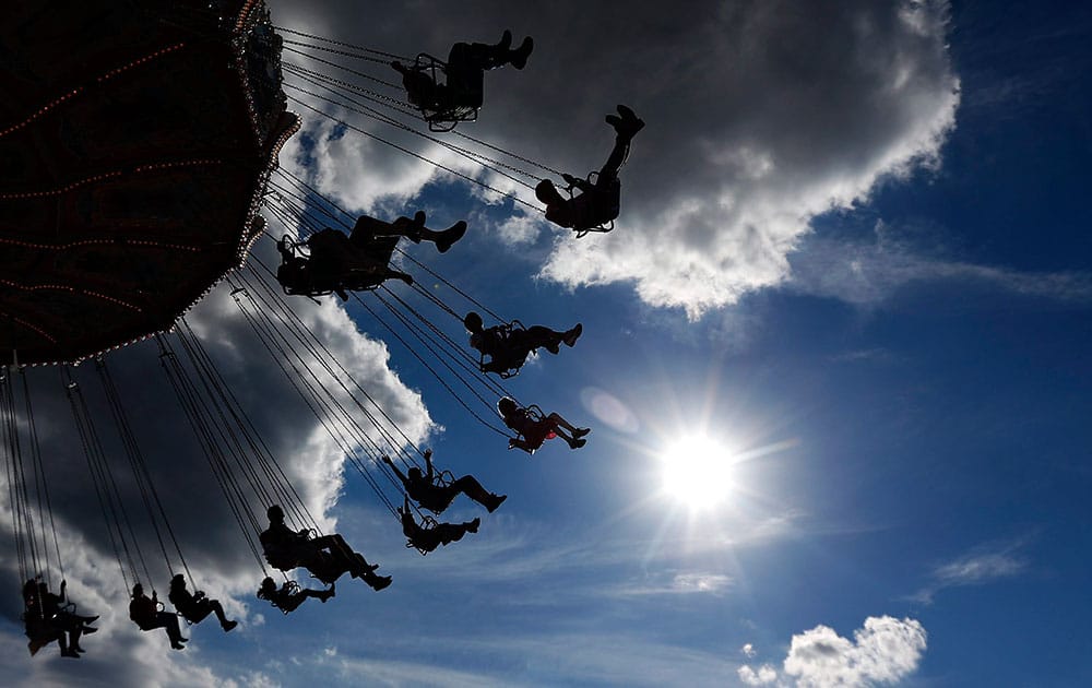 People enjoy a swing ride at the opening day of the 182. Oktoberfest beer festival in Munich, southern Germany.