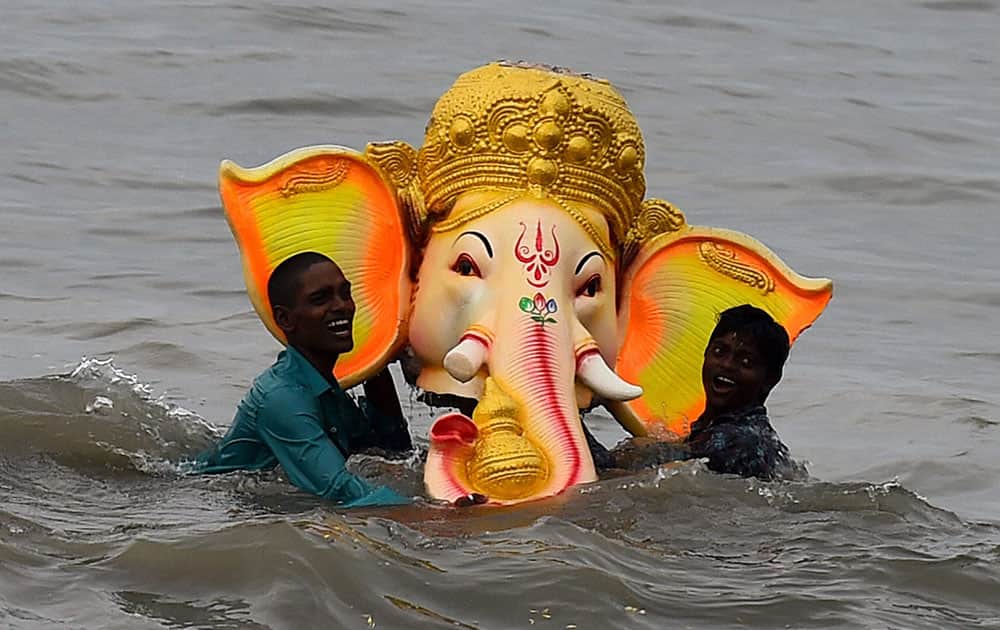 Devotees immerse an idol of Lord Ganesha in the sea, after the Vinayaka Chaturthi festival in Chennai.