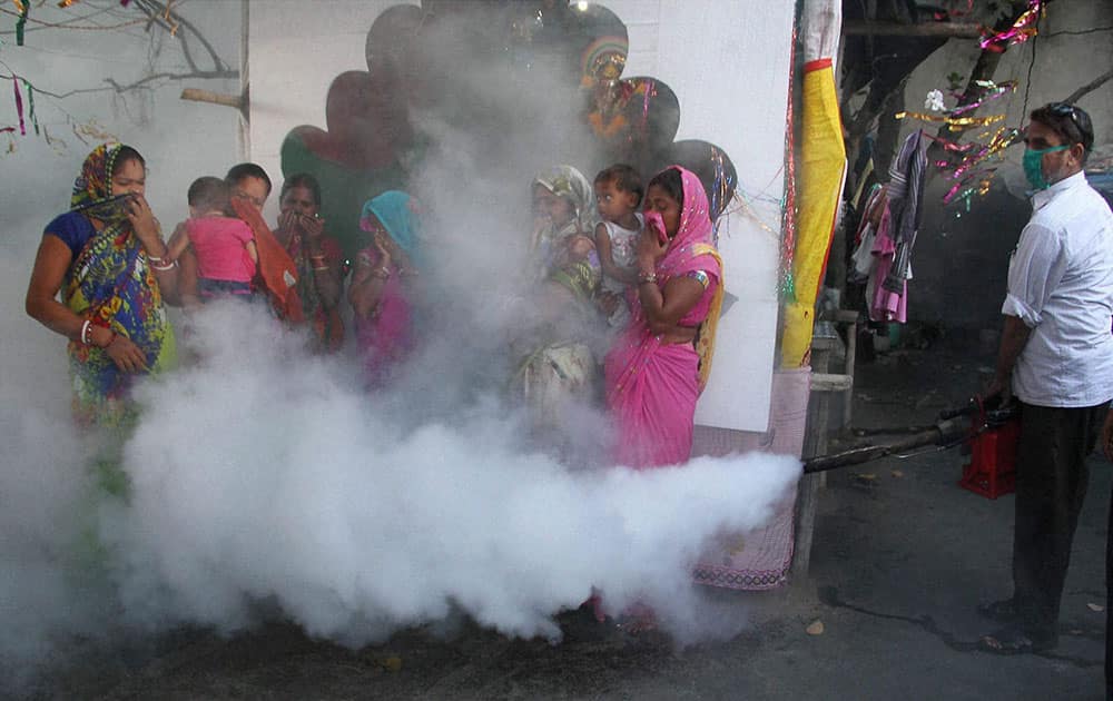 Jammu and Kashmir municipal corporation workers sprays DDT in a residential area to prevent the spread of dengue and other mosquito-borne diseases in Jammu.