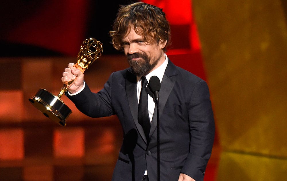 Peter Dinklage accepts the award for outstanding supporting actor in a drama series for “Game of Thrones” at the 67th Primetime Emmy Awards.