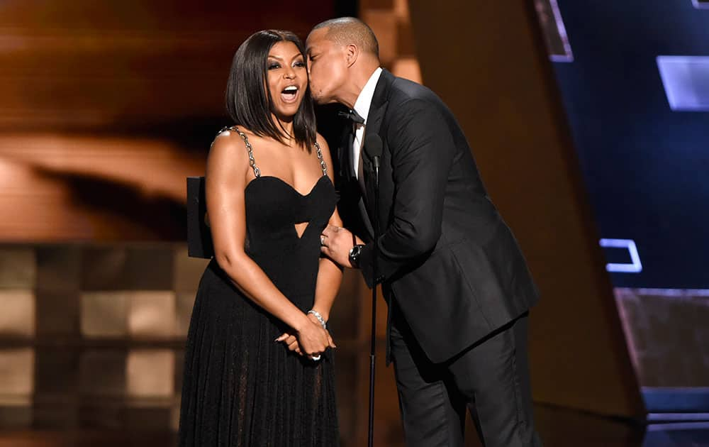 Taraji P. Henson, left, receives a kiss from Terrence Howard as they present the award for outstanding supporting actress in a limited series or a movie at the 67th Primetime Emmy Awards.