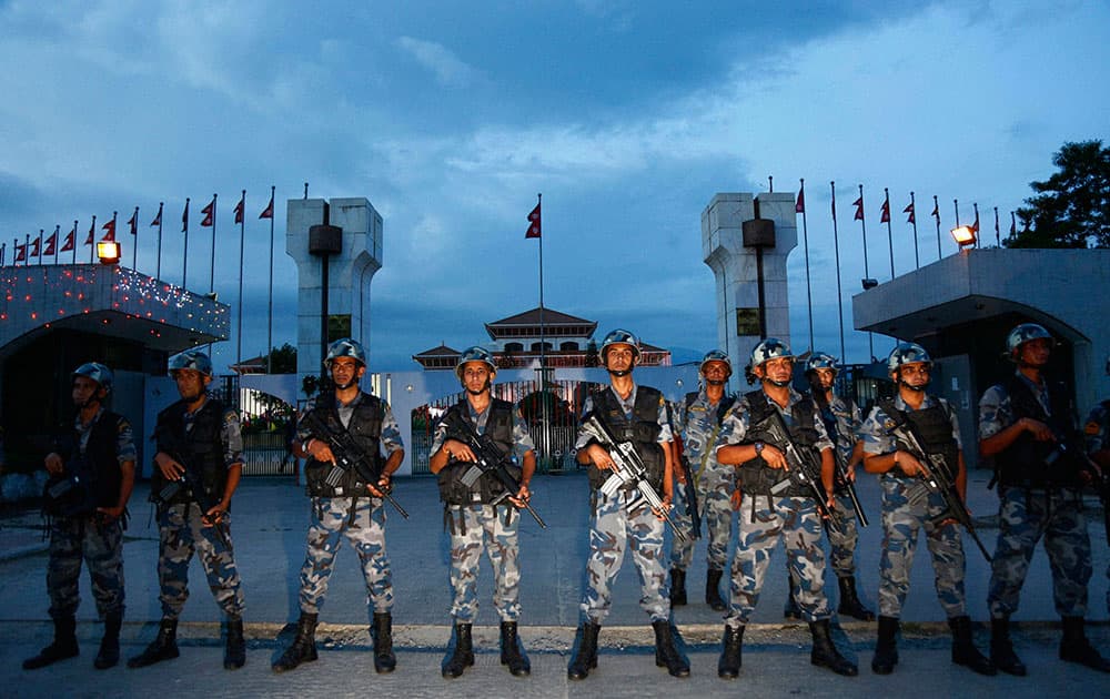 Nepalese policemen stand guard in front of the constituent assembly hall where a ceremony to adopt the countrys new constitution in in progress in Kathmandu, Nepal. Nepalese President Ram Baran Yadav signed the constitution and made the proclamation announcement, setting off a roar of applause from members of the Constituent Assembly in Kathmandu.