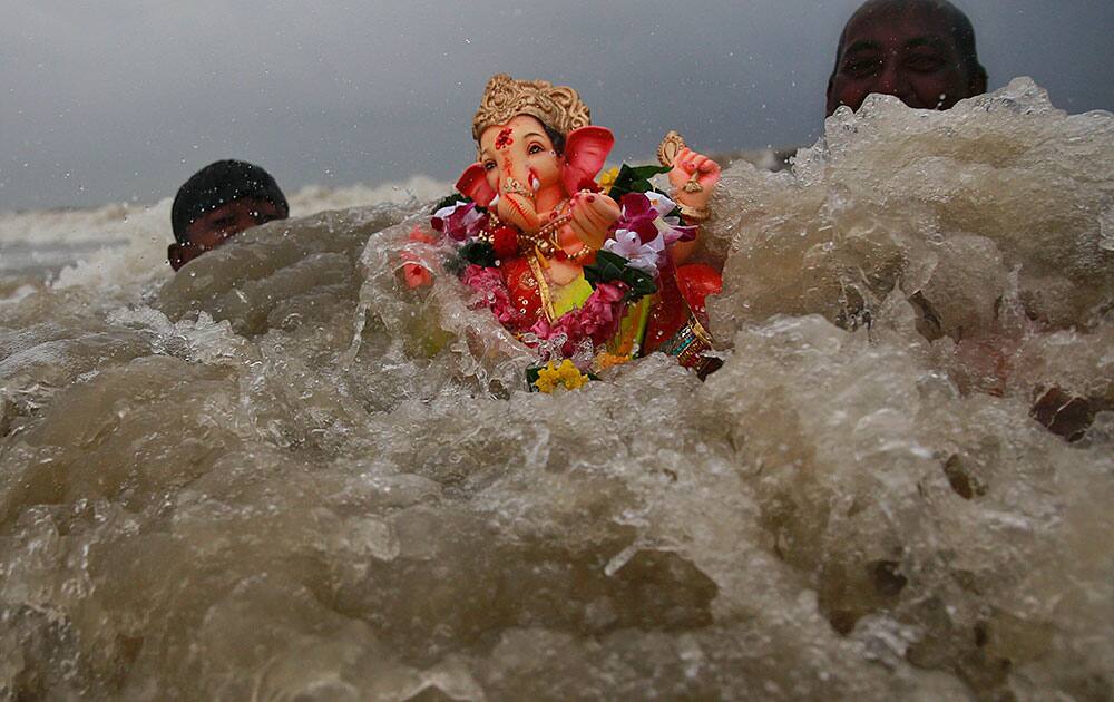 Devotees carry an idol of Hindu god Ganesha for immersing it in the Arabian Sea on the fifth day of the ten day long Ganesh Chaturthi festival in Mumbai.
