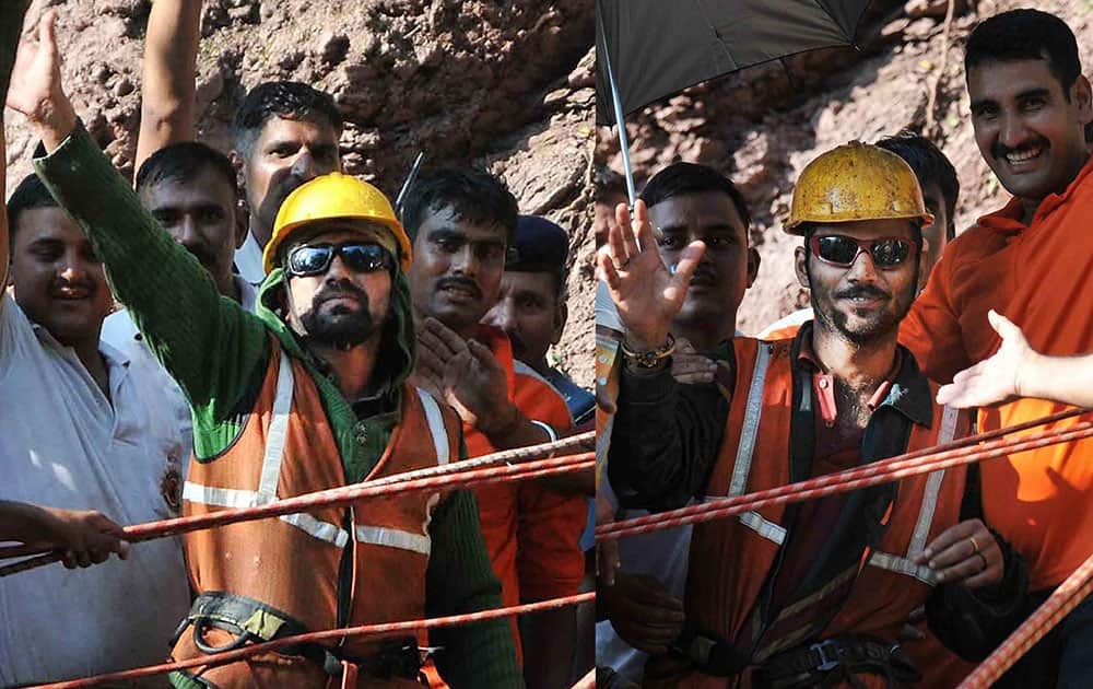 Satish Tomar (R) and Mani Ram, the two tunnel workers who were trapped for nine days inside an under-construction tunnel, wave at the crowd after being brought out by the NDRF team in Bilaspur.