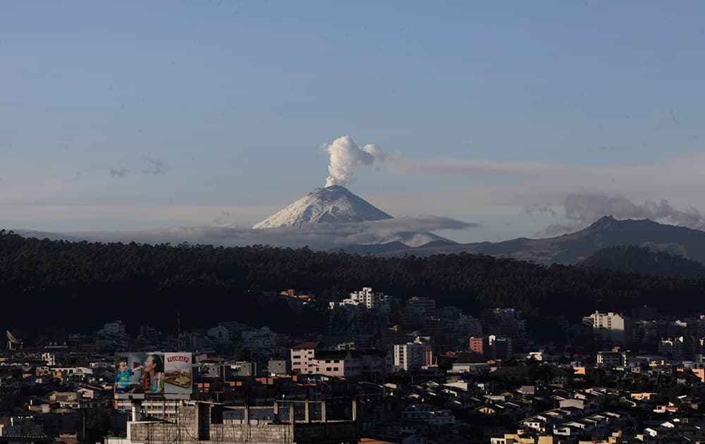 A plume of vapor rises from the Cotopaxi volcano as seen from Quito, Ecuador.