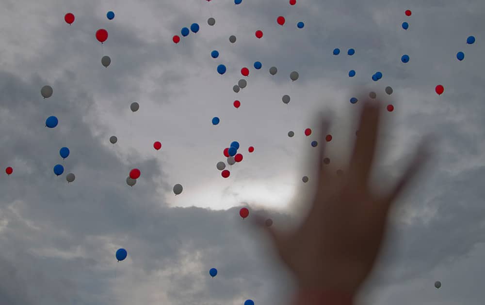 Balloons are released into to the sky after Pope Francis blessed Holguin.