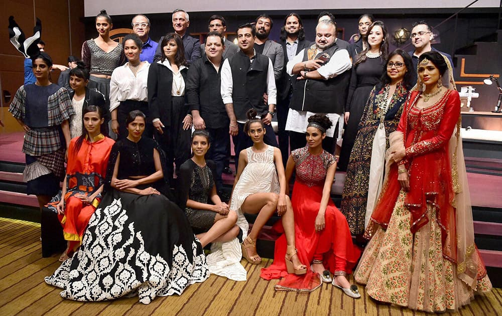 Fashion designers and models pose during a preview of Blenders Pride Fashion Tour 2015 in Mumbai.