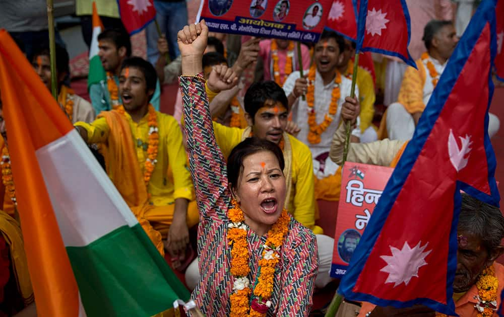 A Nepali woman shouts slogans during a protest against the Nepalese government and demanding it be restored as a Hindu nation, in New Delhi.