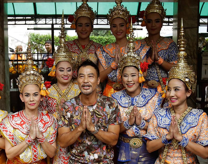 Hong Kong actor Simon Yam pose for photographers with Thai classical dancers at the Erawan Shrine in Bangkok, Thailand.