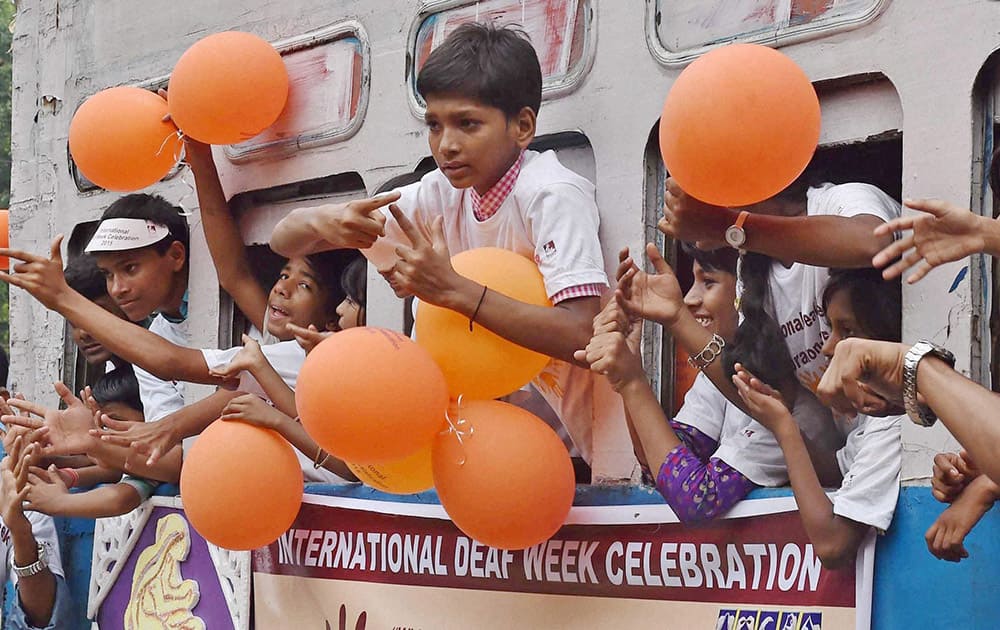 Deaf children enjoy a tram ride during International Deaf Week celebration in Kolkata.
