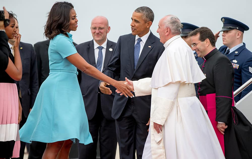 First lady Michelle Obama, accompanied by President Barack Obama, greet Pope Francis upon his arrival at Andrews Air Force Base, Md.