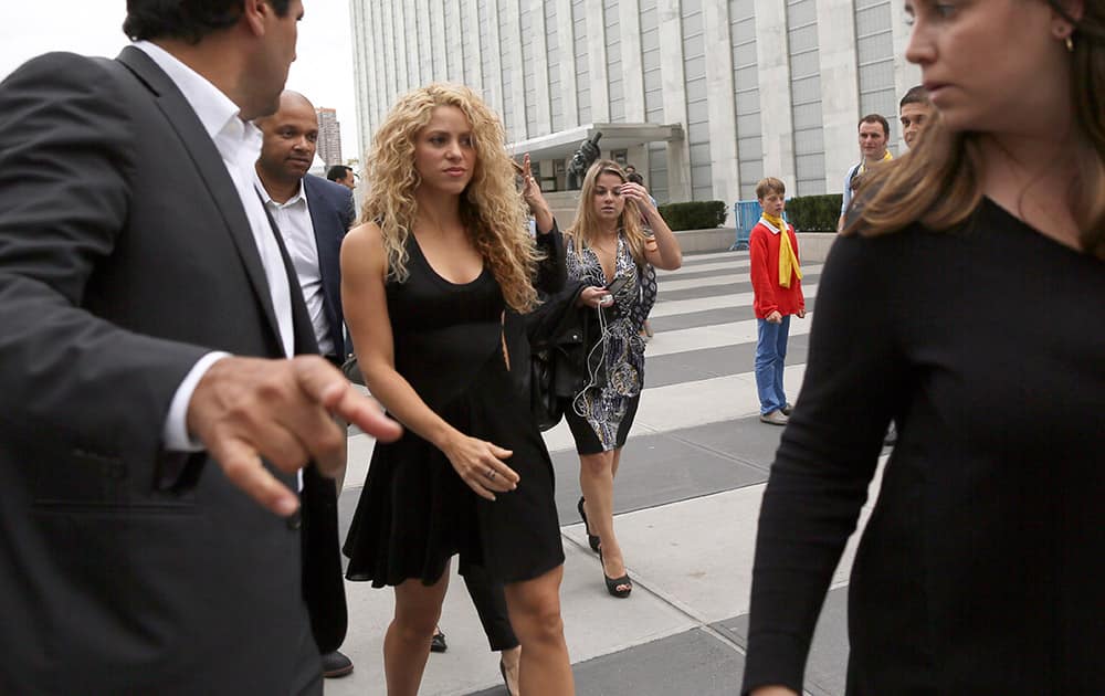 UNICEF and United Nations Goodwill Ambassador Shakira, center, is escorted by her security as she leaves the U.N. headquarters.