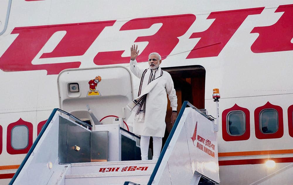 Prime Minister Narendra Modi waves as he departs for his two- nation tour of Ireland and the USA, in New Delhi.