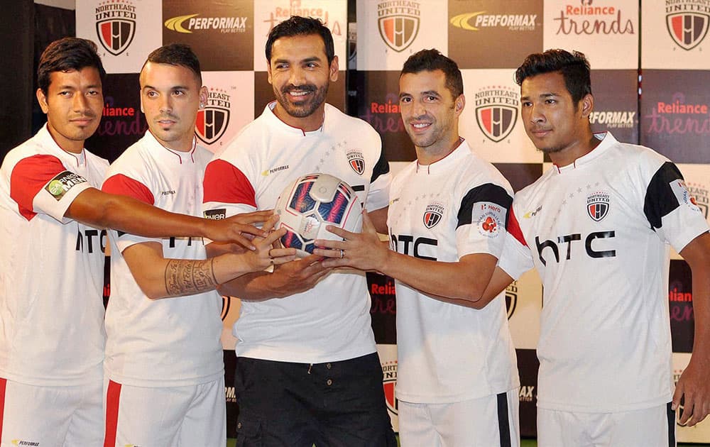 Bollywood actor and Owner of NorthEast United FC John Abraham with team players during Team’s Jersey Launching ceremony ahead of Second edition of Indian Super Leagues (ISL) , in Guwahati.