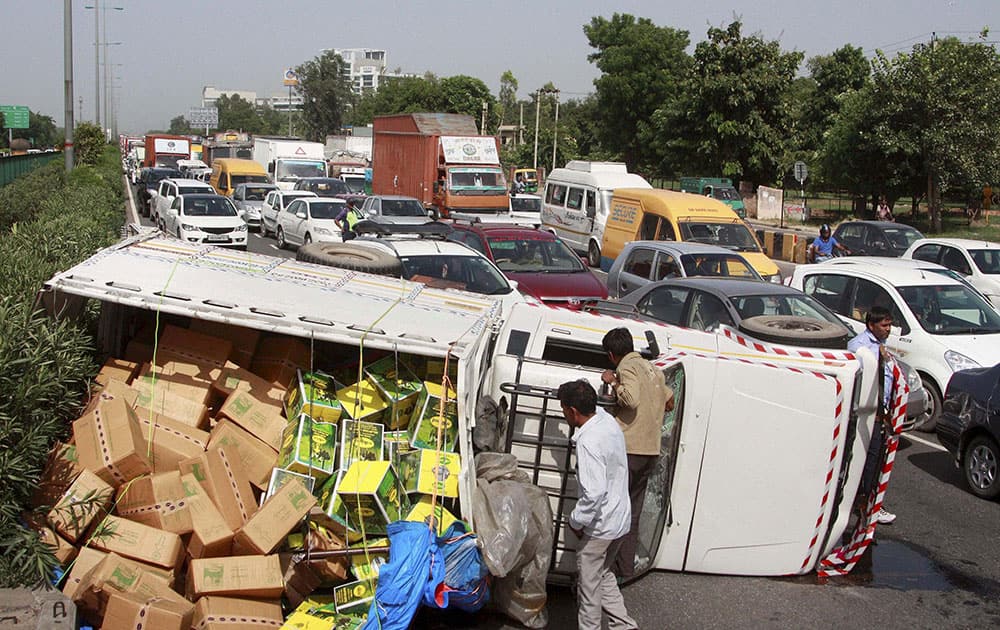 A speedy overloaded vehicle overturns at Delhi Gurgaon Expressway in Gurgaon.