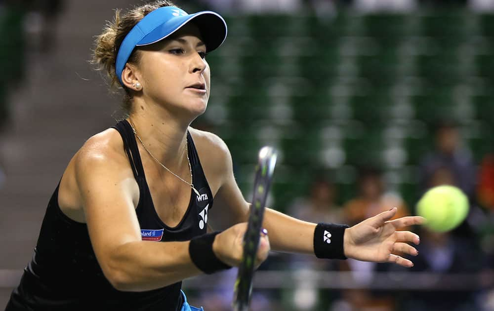 Belinda Bencic of Switzerland returns a shot against Garbine Muguruza of Spain during a quarterfinal match at the Pan Pacific Open women’s tennis tournament in Tokyo.