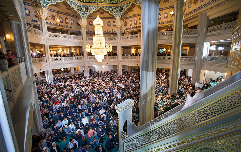 Russia's top Muslim Cleric Ravil Gainutdin, right, conducts a religious service inside the newly restored Moscow Cathedral Mosque during celebrations of Eid al-Adha, a feast celebrated by Muslims worldwide, which Muslims in Russia call Kurban-Bairam, in Moscow, Russia.