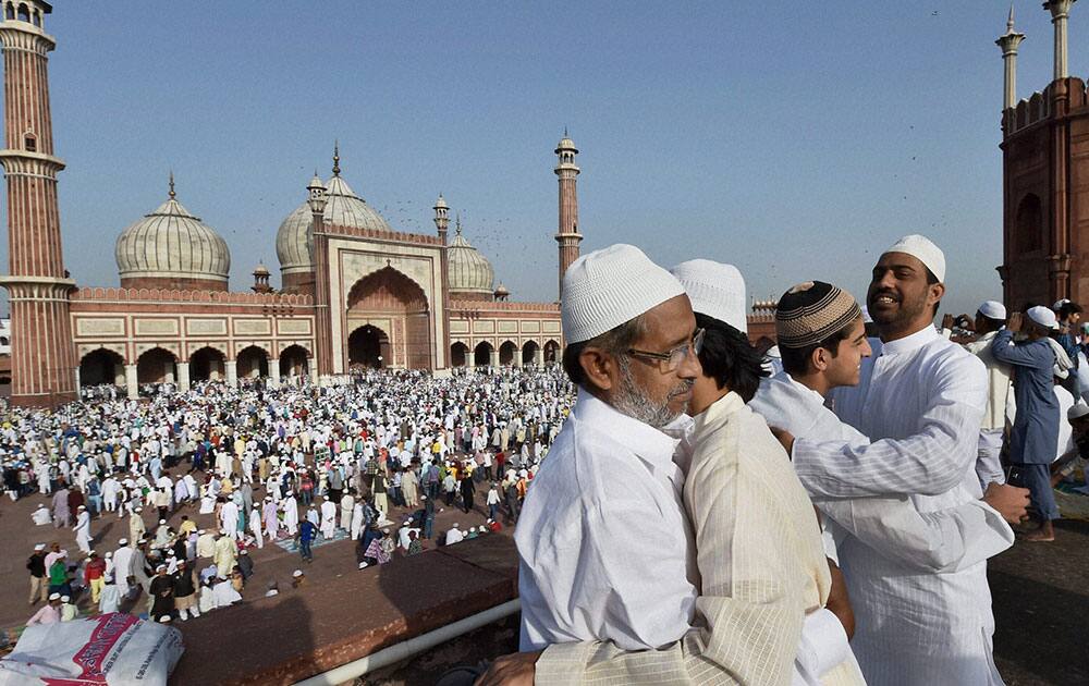 Muslims greet each other after offering prayers on the occasion of Eid al-Adha at Jama Masjid in New Delhi.