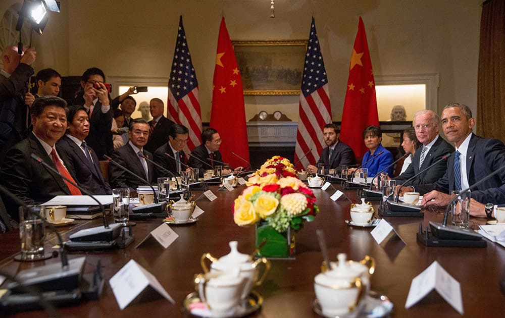 President Barack Obama, right, accompanied with Vice President Joe Biden, second from right, holds a bilateral meeting with Chinese President Xi Jinping, left, and other officials, in the Cabinet Room of the White House in Washington.