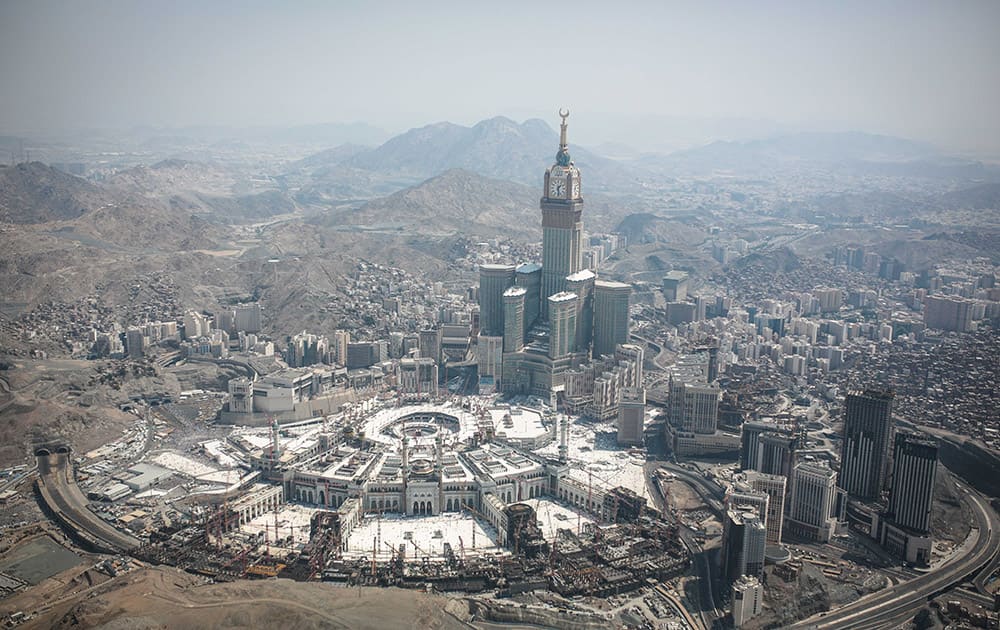 This aerial photo made from a helicopter, the Abraj Al-Bait Towers with the four-faced clocks stands over the holy Kaaba, as Muslims encircle it inside the Grand Mosque, during the annual pilgrimage known as the hajj, in the Muslim holy city of Mecca, Saudi Arabia.