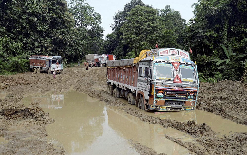 Vehicles stranded at NH 44 damaged due to incessant rains at Churaibari in Tripura.