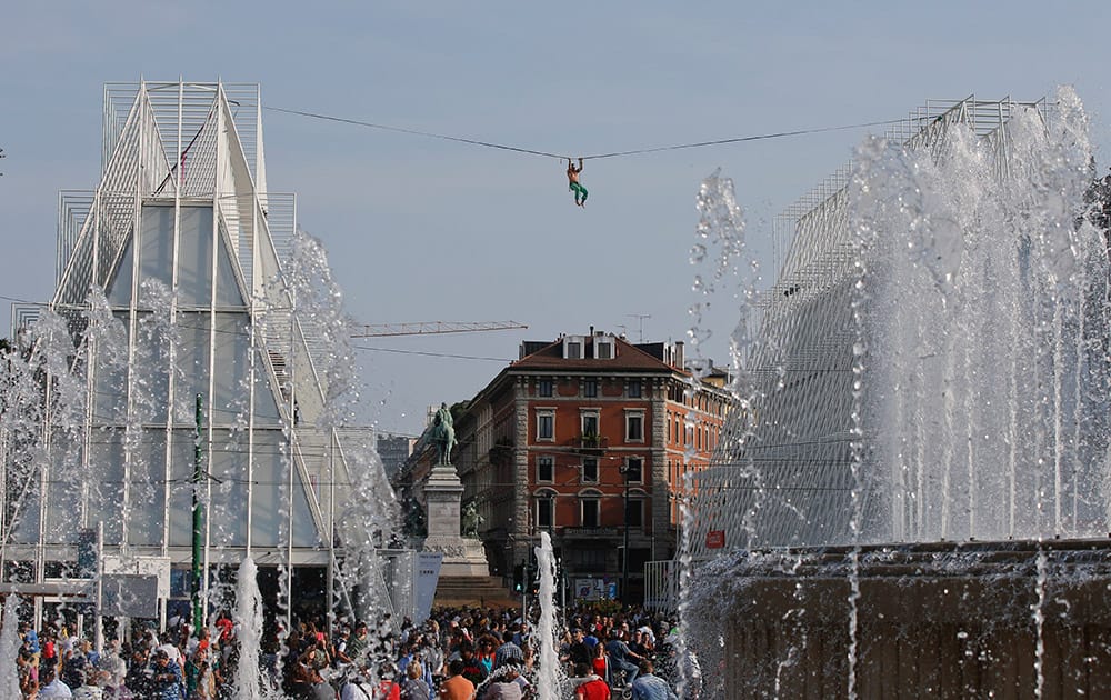 Sirio Izzo, a tightrope walker, performs in 'Highline' during 'Stra' Street Artist Festival in Milan, Italy.