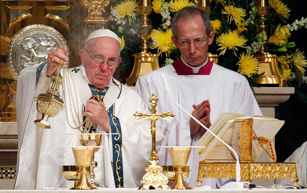 Pope Francis blesses the bread and the Blood of Christ during a Mass at Cathedral Basilica of Sts. Peter and Paul, in Philadelphia.