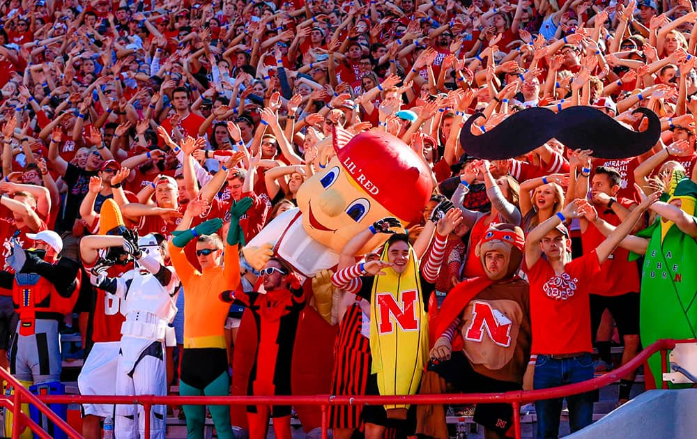 Nebraska mascot Lil' Red joins fans as they celebrate a Nebraska touchdown against Southern Miss in the first half of an NCAA college football game in Lincoln, Neb.