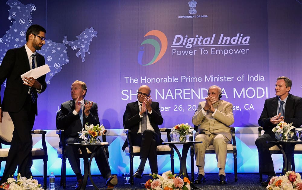 Prime Minister Narendra Modi claps with Microsoft CEO Satya Nadella, John T. Chambers, Executive Chairman of Cisco, Paul E. Jacobs, Executive Chairman of Qualcomm as Google CEO Sundar Pichai (L) walks to his seat after his speech during the Digital India and Digital Technology dinner function in San Jose.