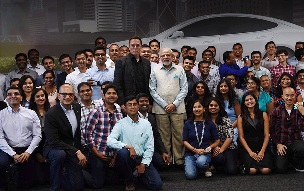 Prime Minister Narendra Modi and Elon Reeve Musk, CEO and Product Architect of Tesla Motors with employees pose a photo during a visit of TESLA motors facility in San Jose.