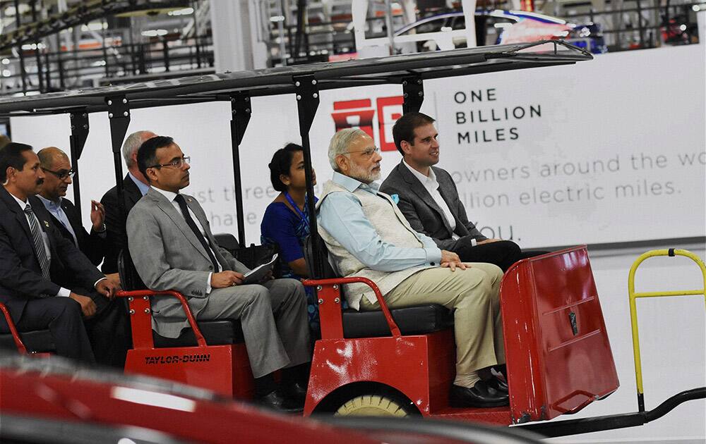 Prime Minister Narendra Modi takes ride in electric car during a visit of TESLA motors facility in San Jose.